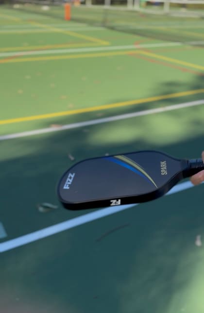 A FIZZ paddle in hand on a club court in Newcastle